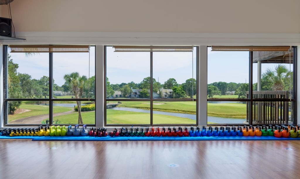 weights in front of a window overlooking the golf course