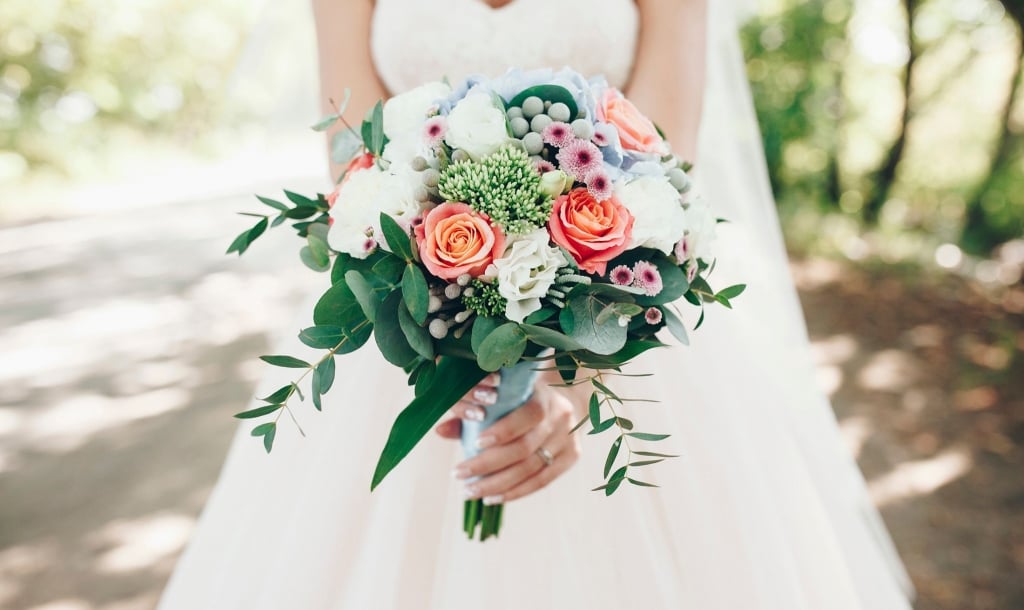 Bride standing outside with a beautiful bouquet