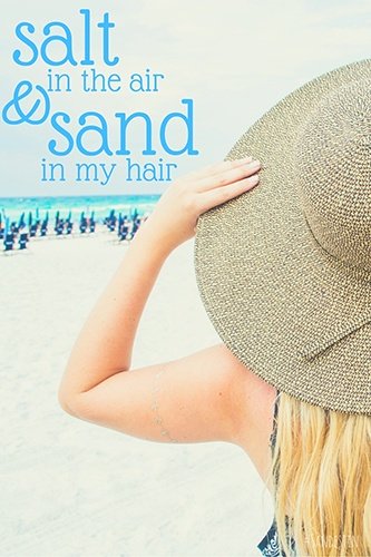 Woman with a straw beach hat and "Salt in the air and sand in my hair"