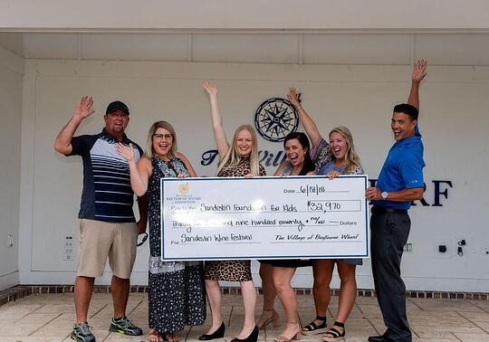 Sandestin Golf and Beach Resort presenting a check 