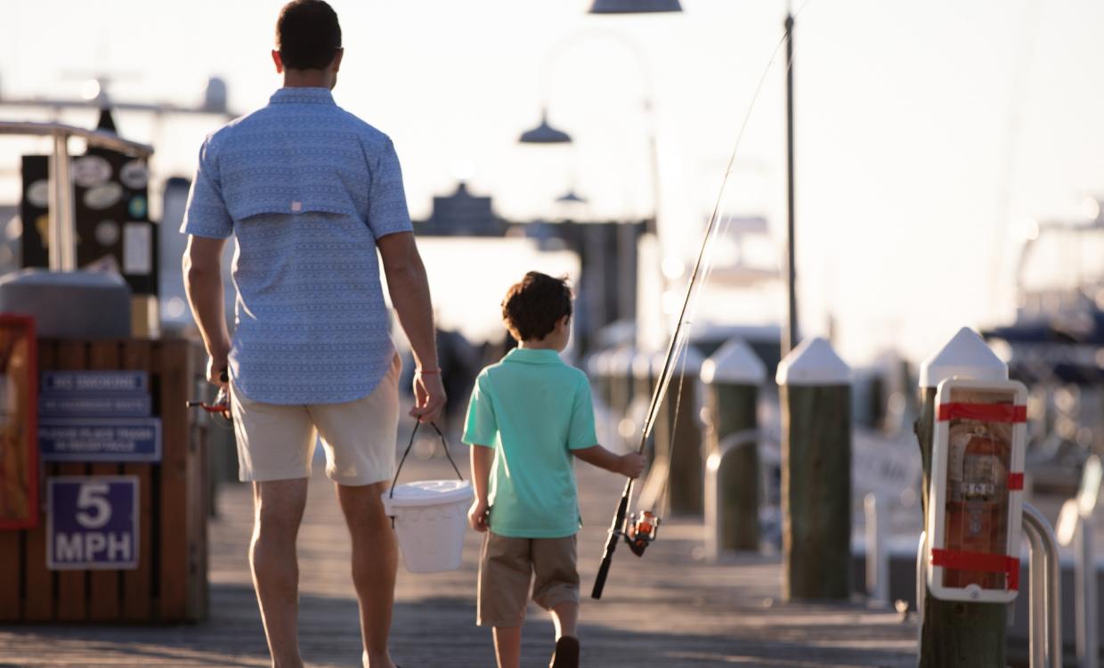 Father and Son walking on fishing dock