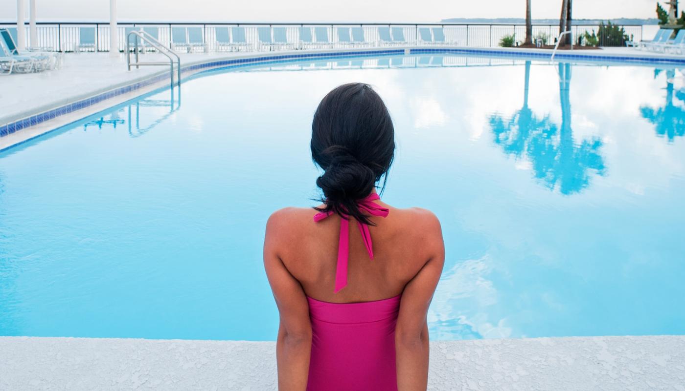 Woman sitting on the edge of a pool