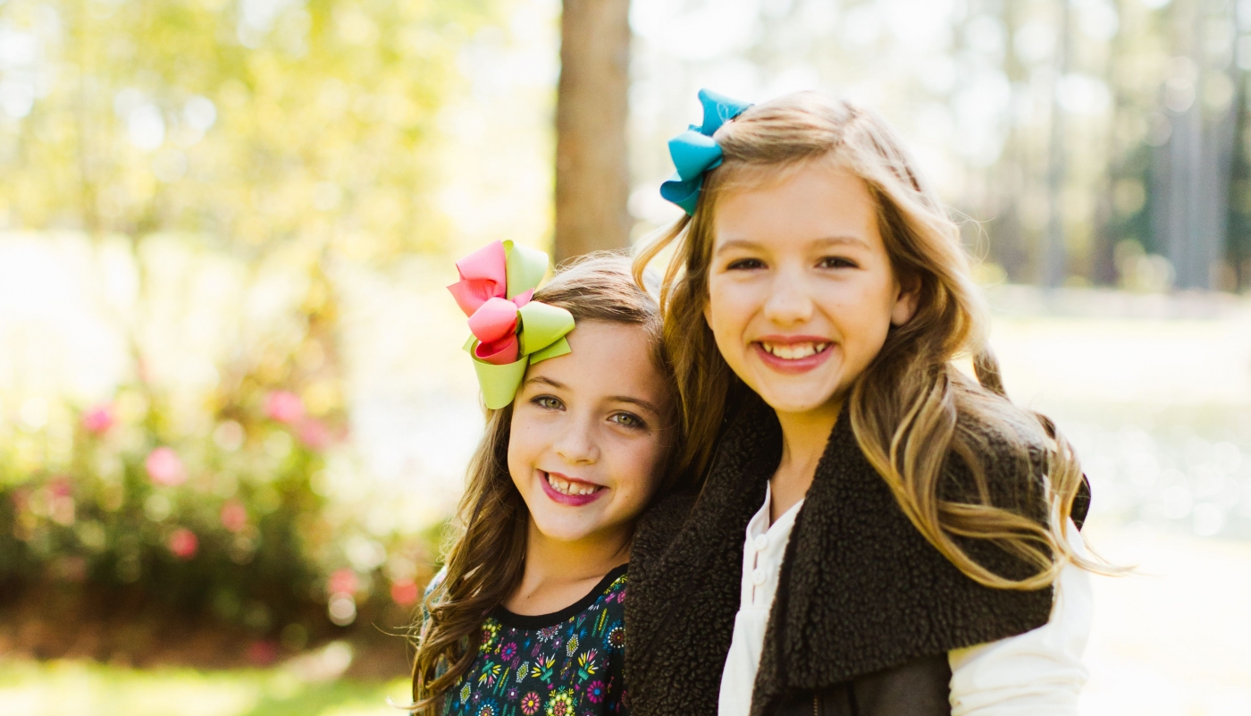 Two girls dressed in fall clothing from coconut kidz at Sandestin Golf and Beach Resort