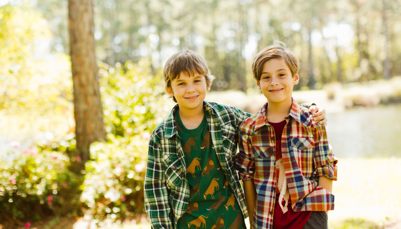 Two boys dressed in plain shirts and jeans