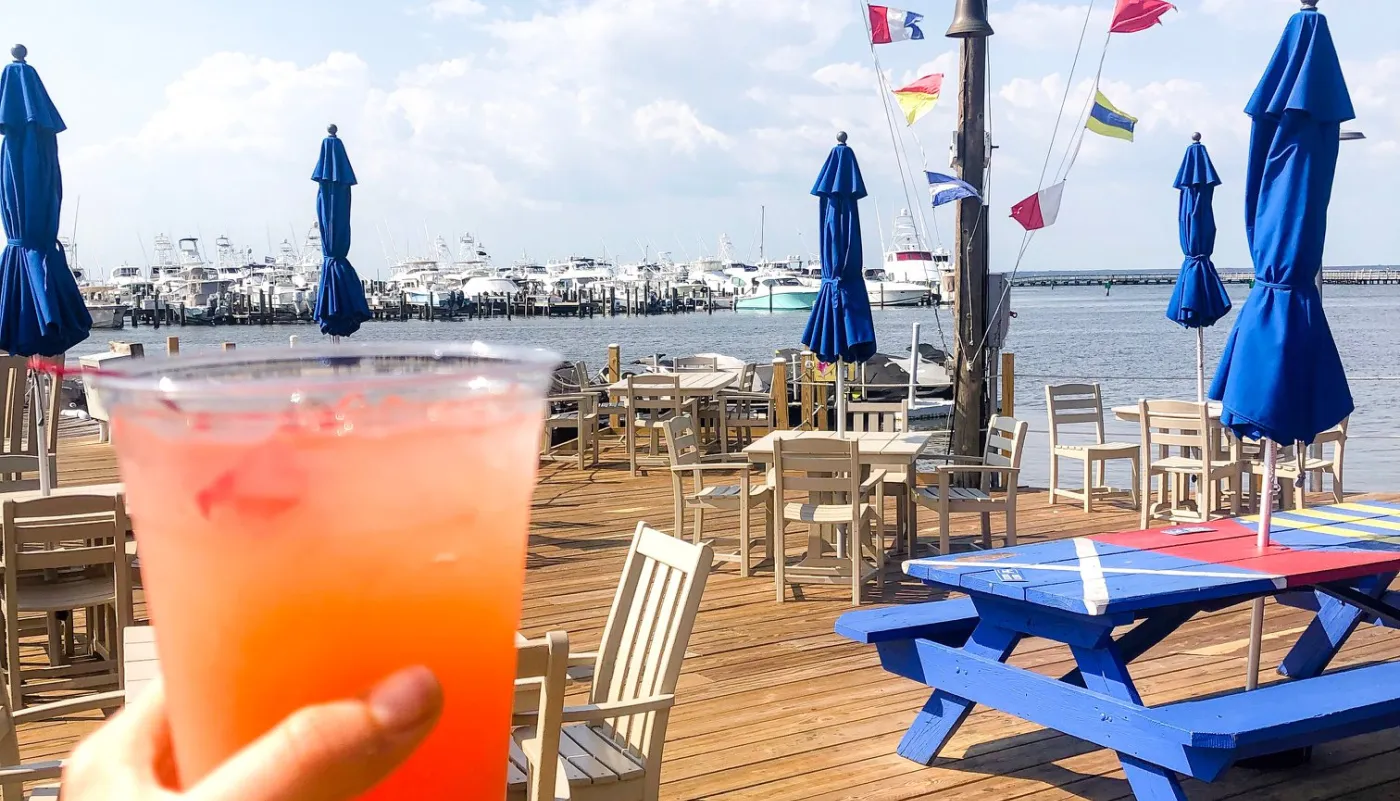 a frozen drink with the patio of Marina Bar & Grill in the background