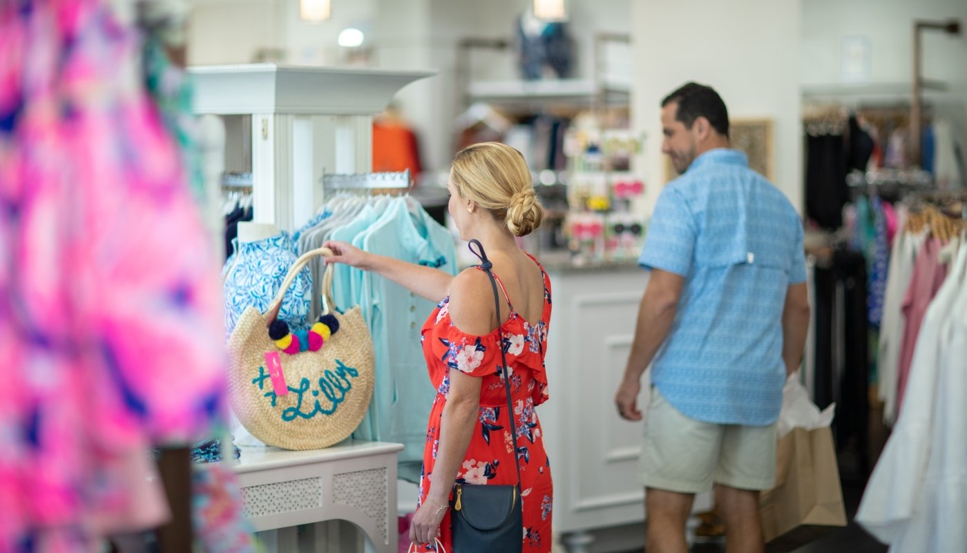 woman looking at a handbag that is for sale at Barefoot Princess