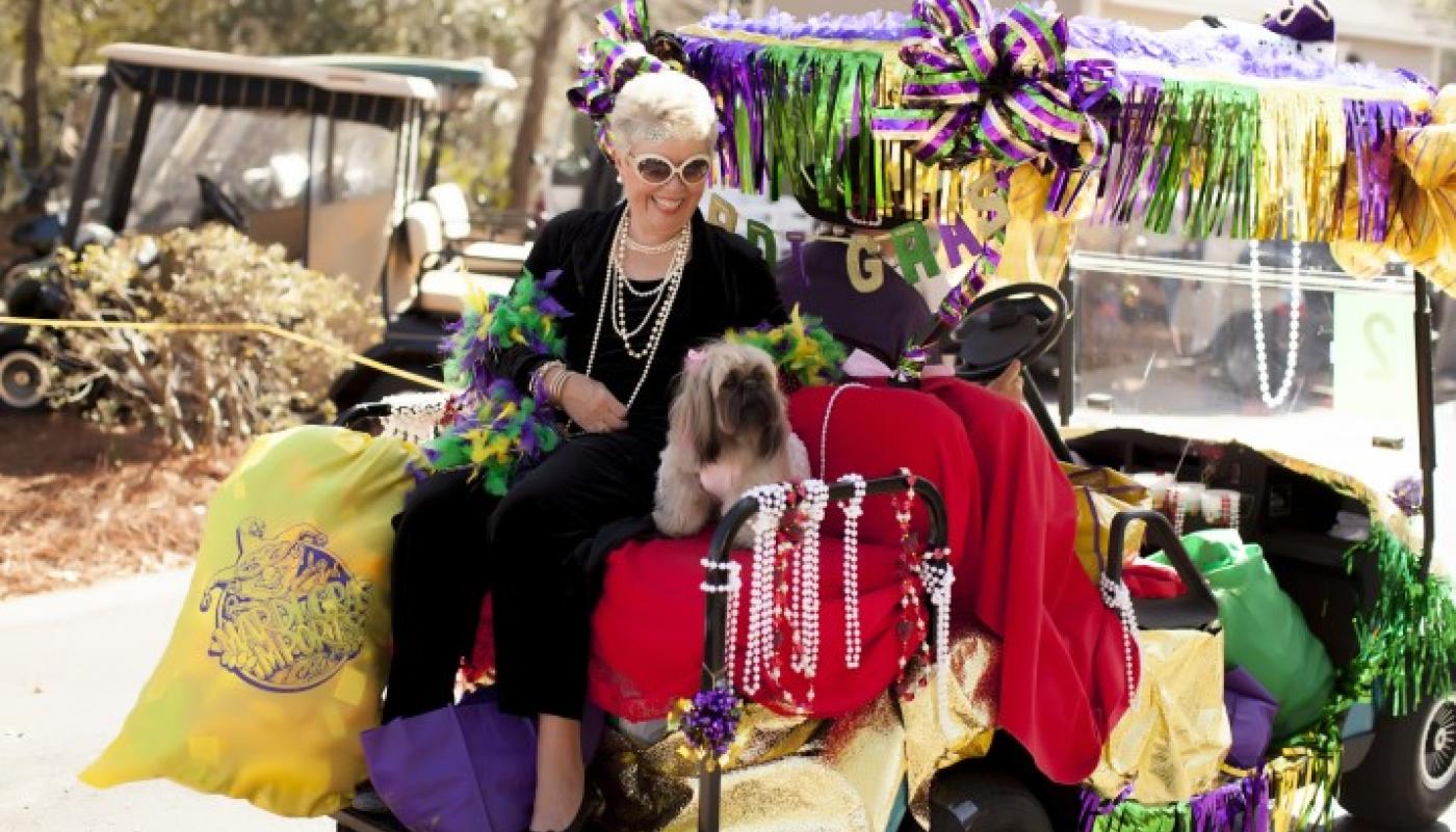 woman and dog on golf cart