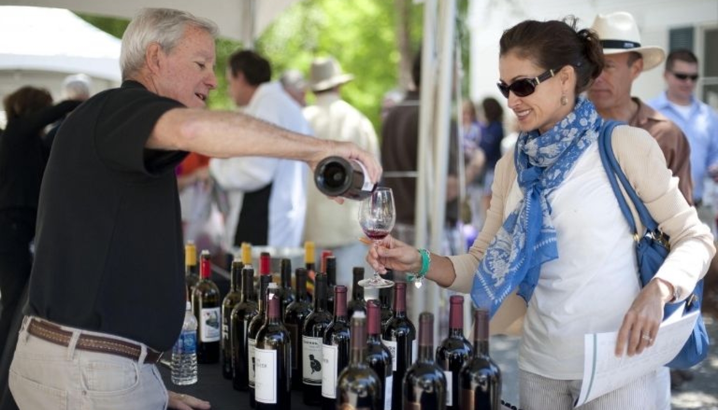 Man pours woman glass of wine