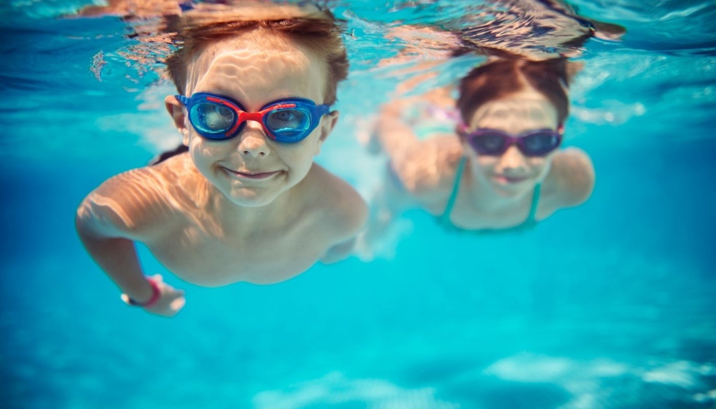 two kids swimming underwater