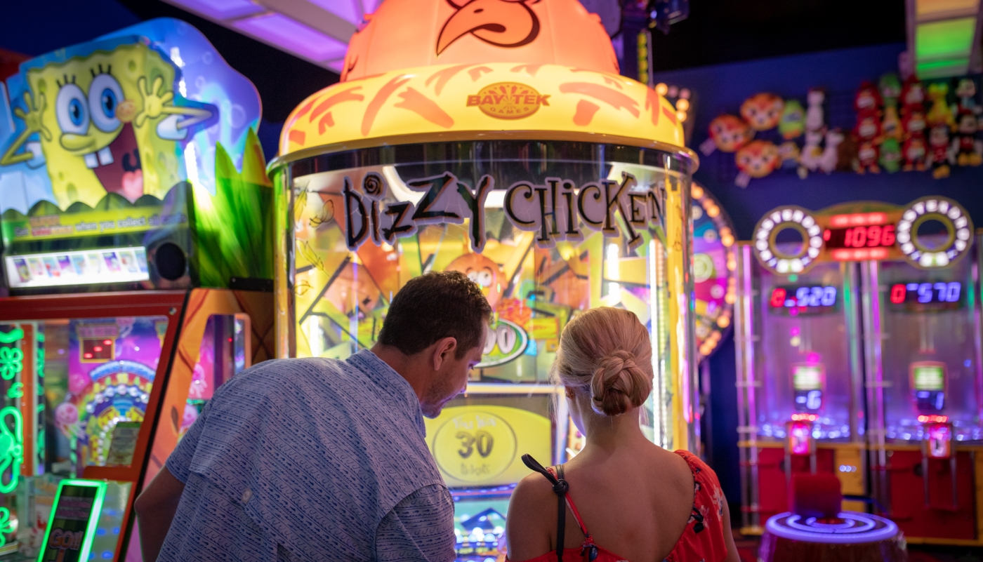 two people playing arcade games