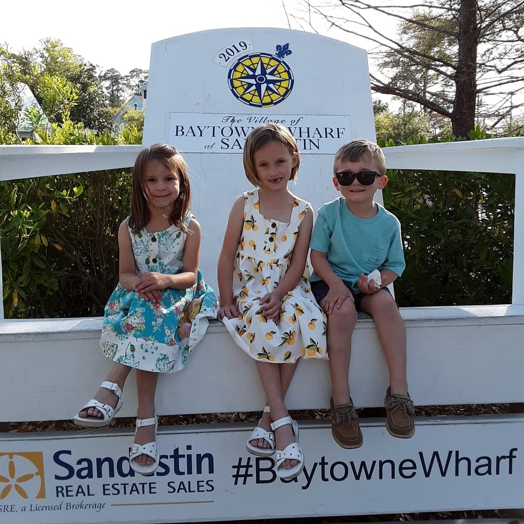 Children Sitting in the large chair at Baytowne Wharf