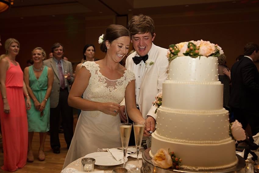 bride and groom cutting wedding cake