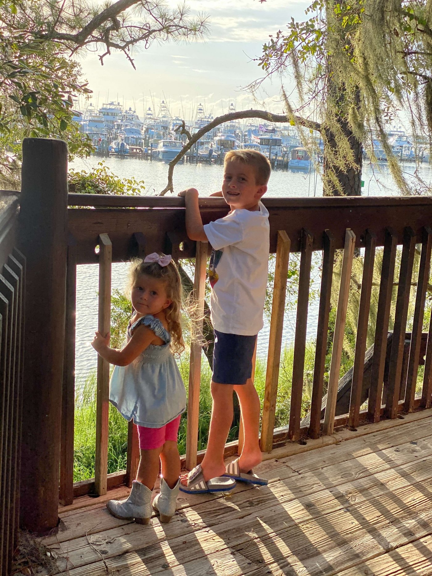 Children on the deck looking out over the water