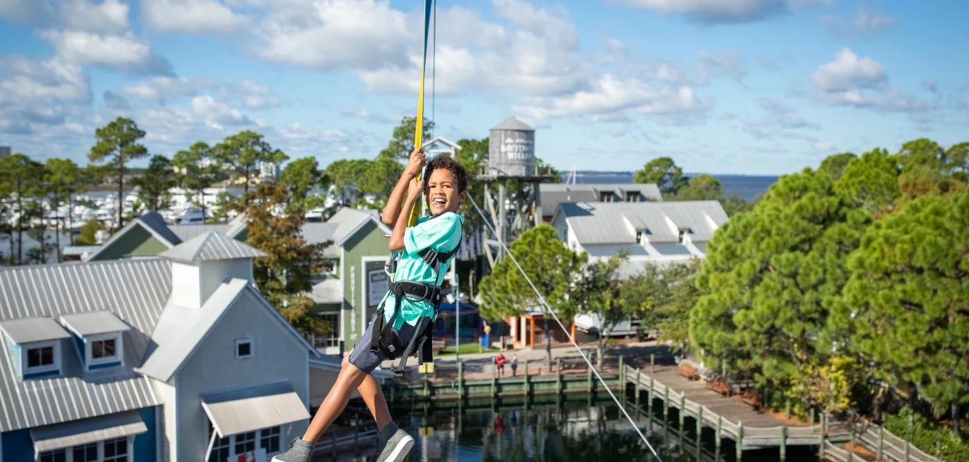 Kid zip lining at Baytowne