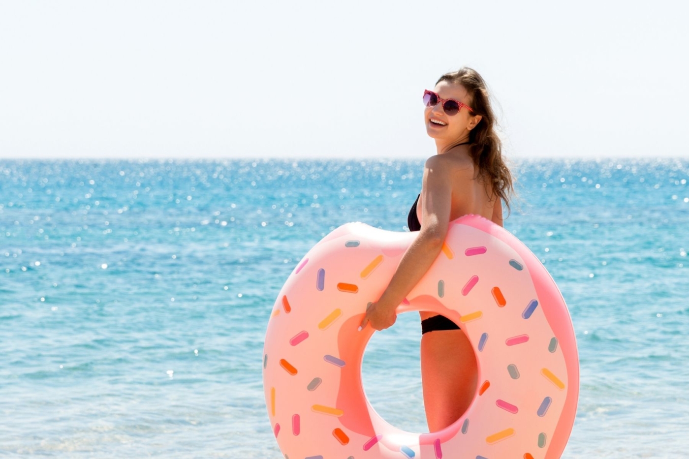 Woman holding a float on the beach