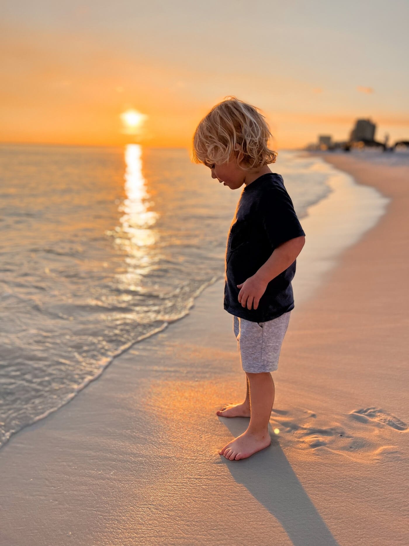 kid on beach during sunset