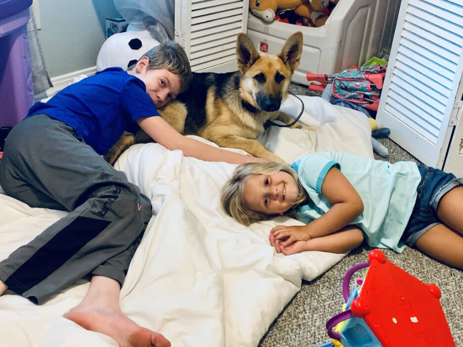 Remi Lewis and his sister with their dog, Willow