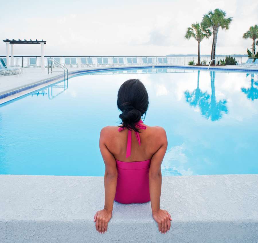 Woman sitting on the edge of a pool