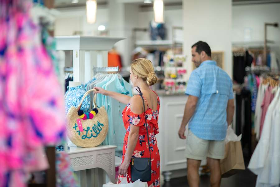 woman looking at a handbag that is for sale at Barefoot Princess
