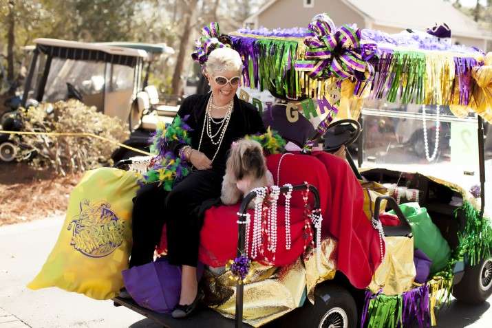 woman and dog on golf cart
