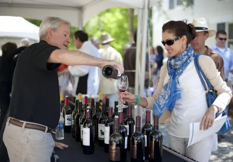 Man pours woman glass of wine