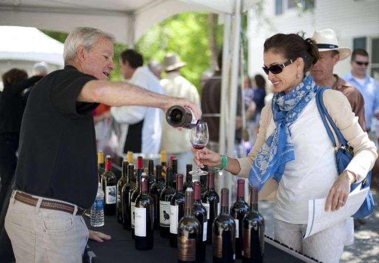 Man pours woman glass of wine