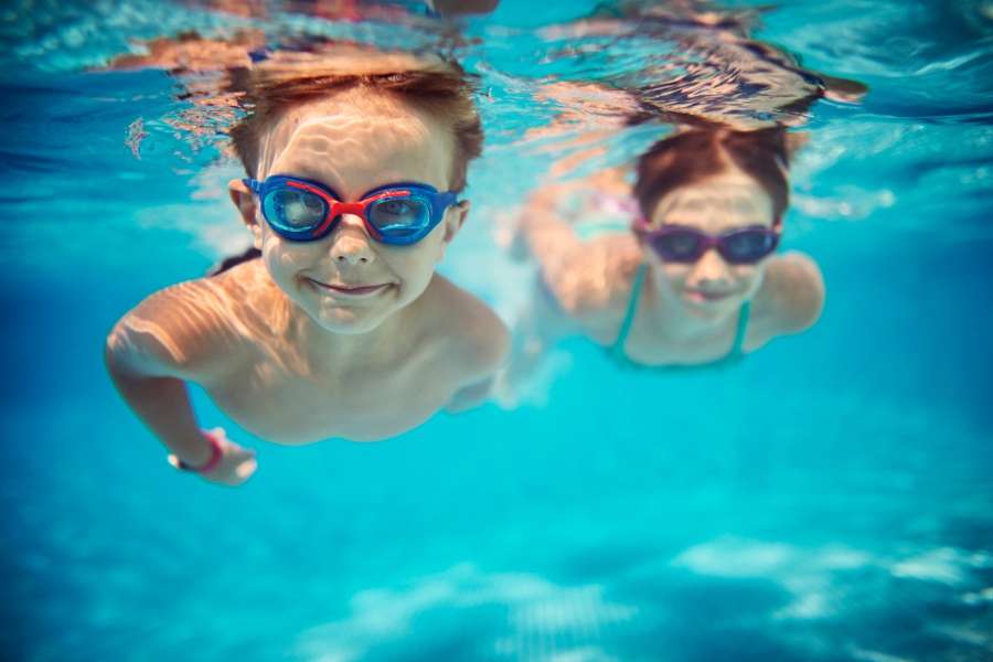 two kids swimming underwater