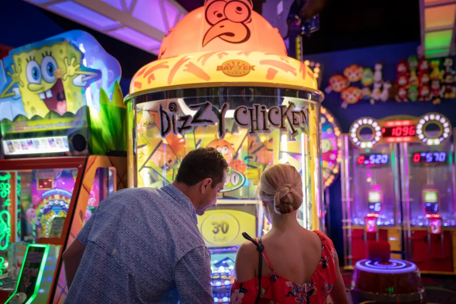two people playing arcade games