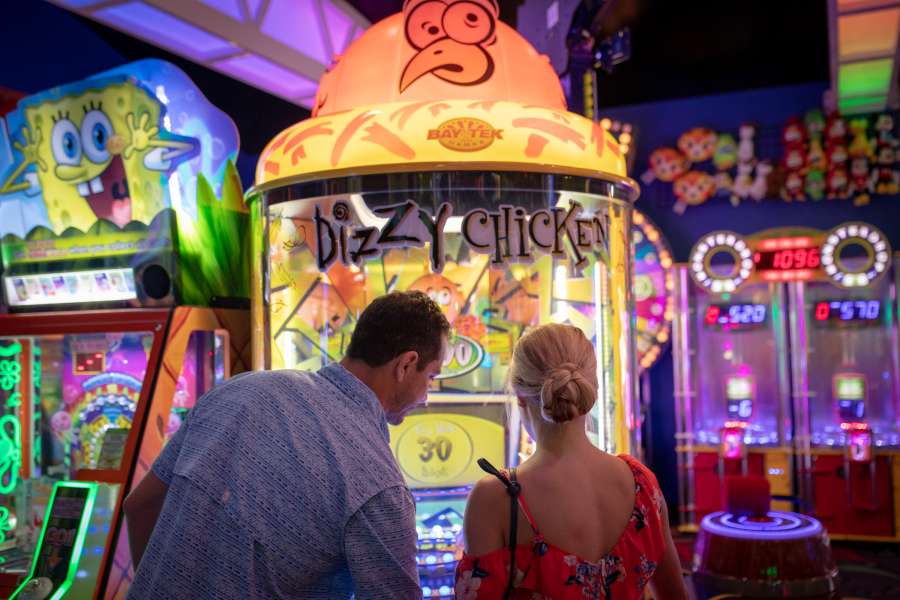 two people playing arcade games