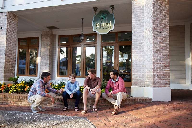 Men sitting in front of store
