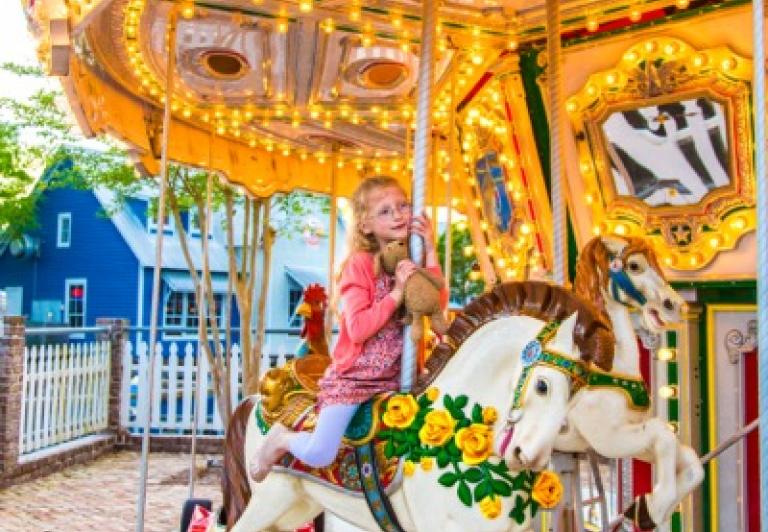 girl riding the carousel 