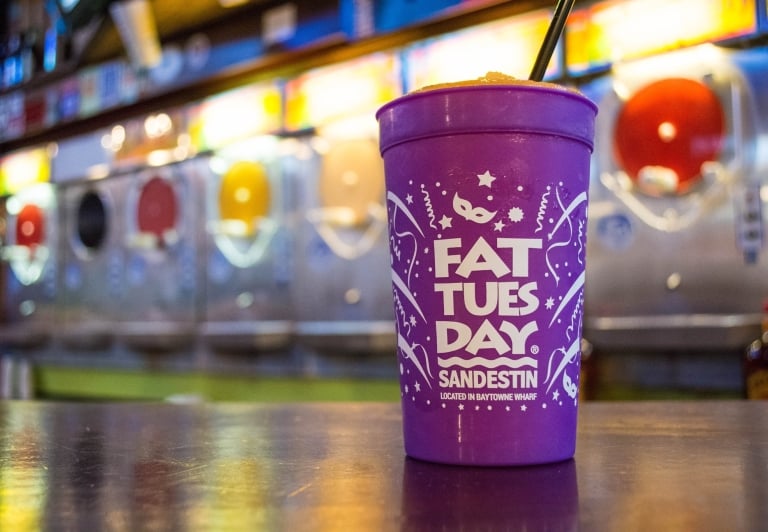 Fat Tuesday purple cup sitting on a bar