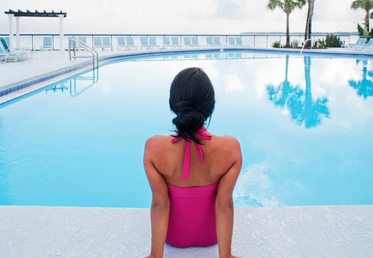 Woman sitting on the edge of a pool