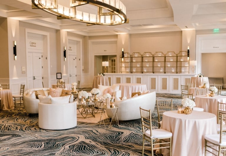 Azalea Ballroom set up for a wedding with white tables and chairs