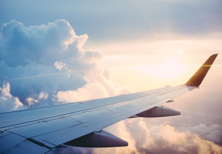 view out an airplane window, looking at the clouds