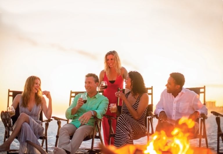 group having a bonfire on the beach