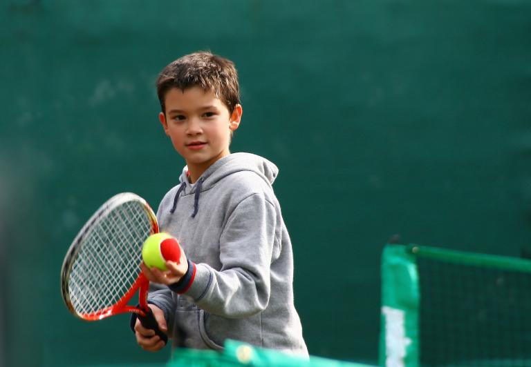 Chid playing tennis