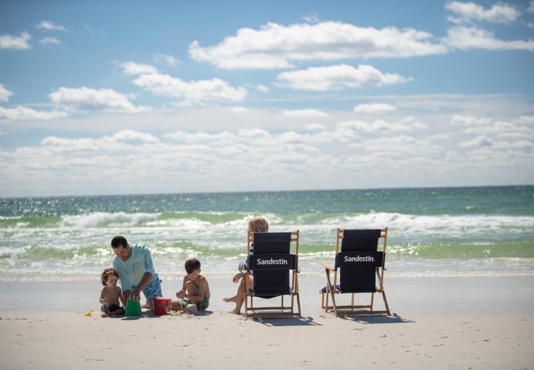 family on the beach with beach chairs