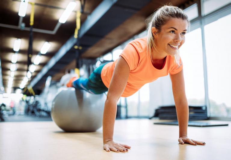 woman doing a plank on a stability ball