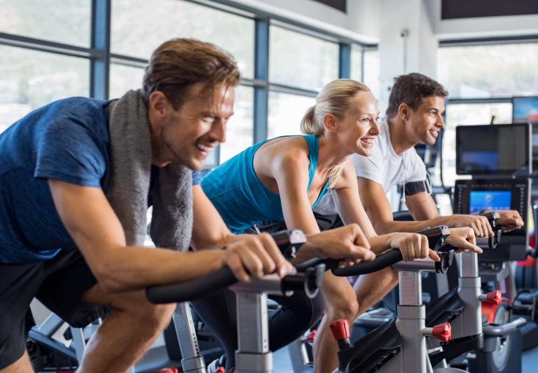 men and women in a spin class