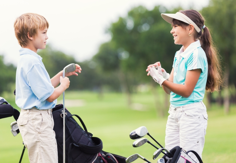 boy and girl playing golf