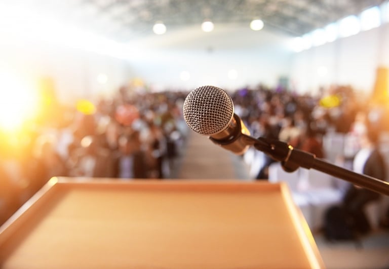 looking out over a speaking podium at an event