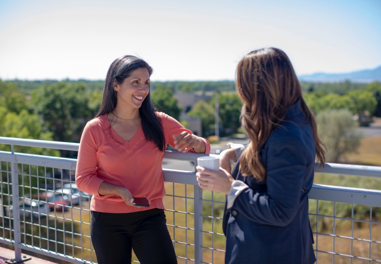 women talking on a patio