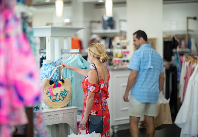 woman looking at a handbag that is for sale at Barefoot Princess