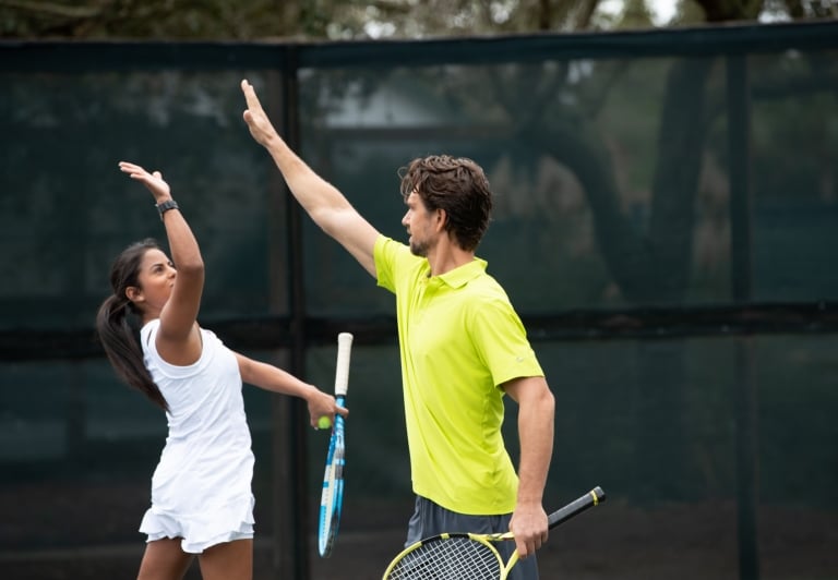 couple giving each other a high-five after playing tennis