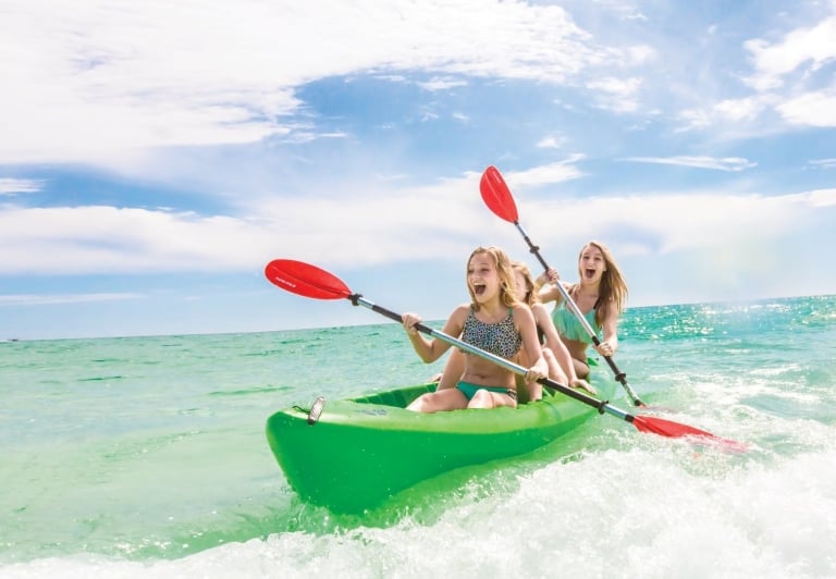 Youth paddling in a kayak