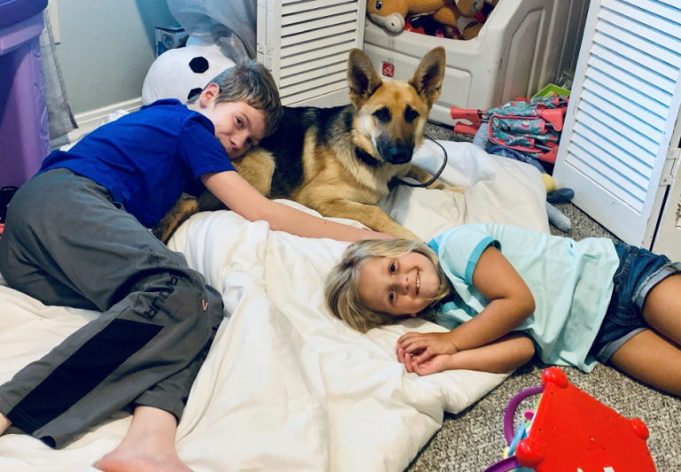 Remi Lewis and his sister with their dog, Willow