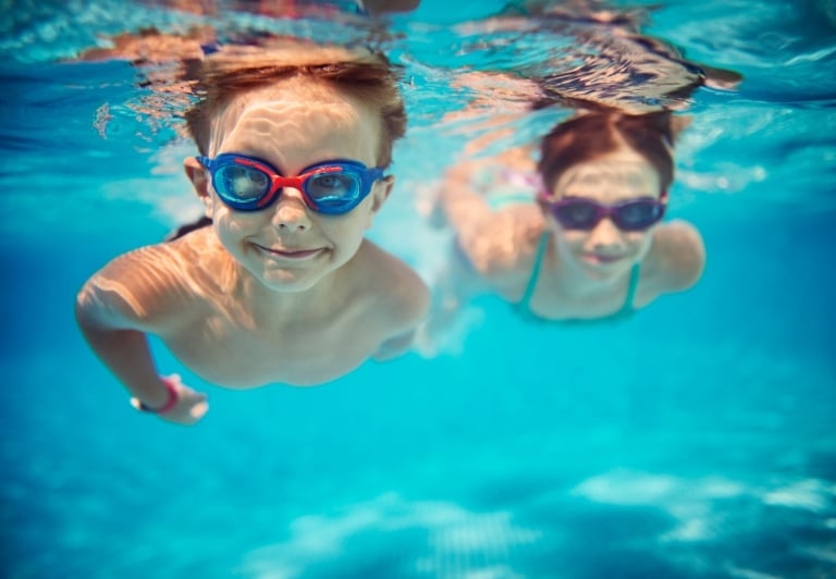 two kids swimming underwater