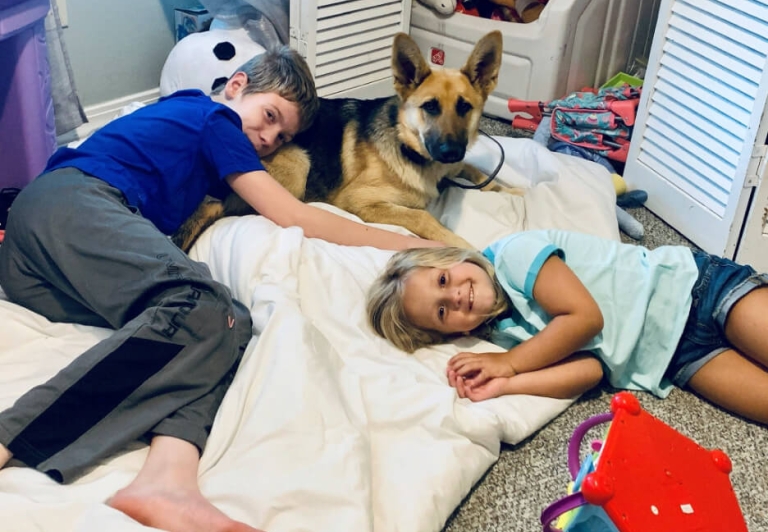 Remi Lewis and his sister with their dog, Willow