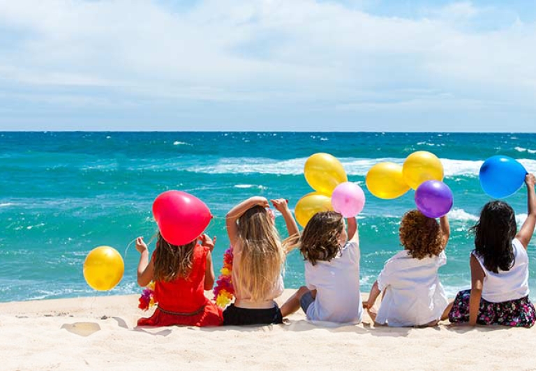 Kids on beach with balloons